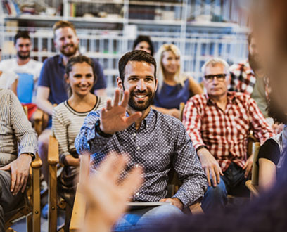 A group of people sitting for a presentation