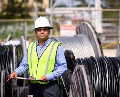 Employee wearing a hard hat and safety vest