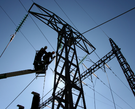 NextEra employees working on an electric tower line.